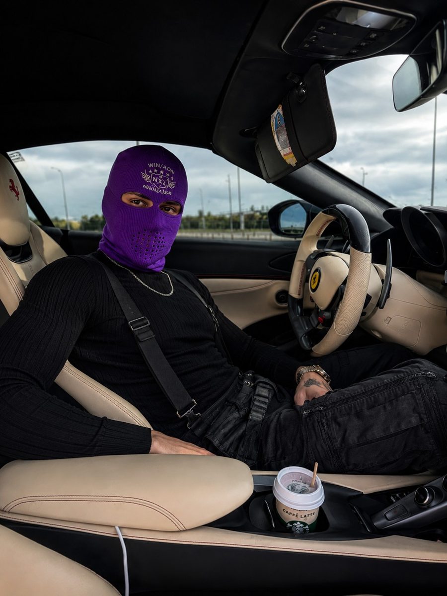 El personaje de ECOMMER, con pasamontañas morado, al volante